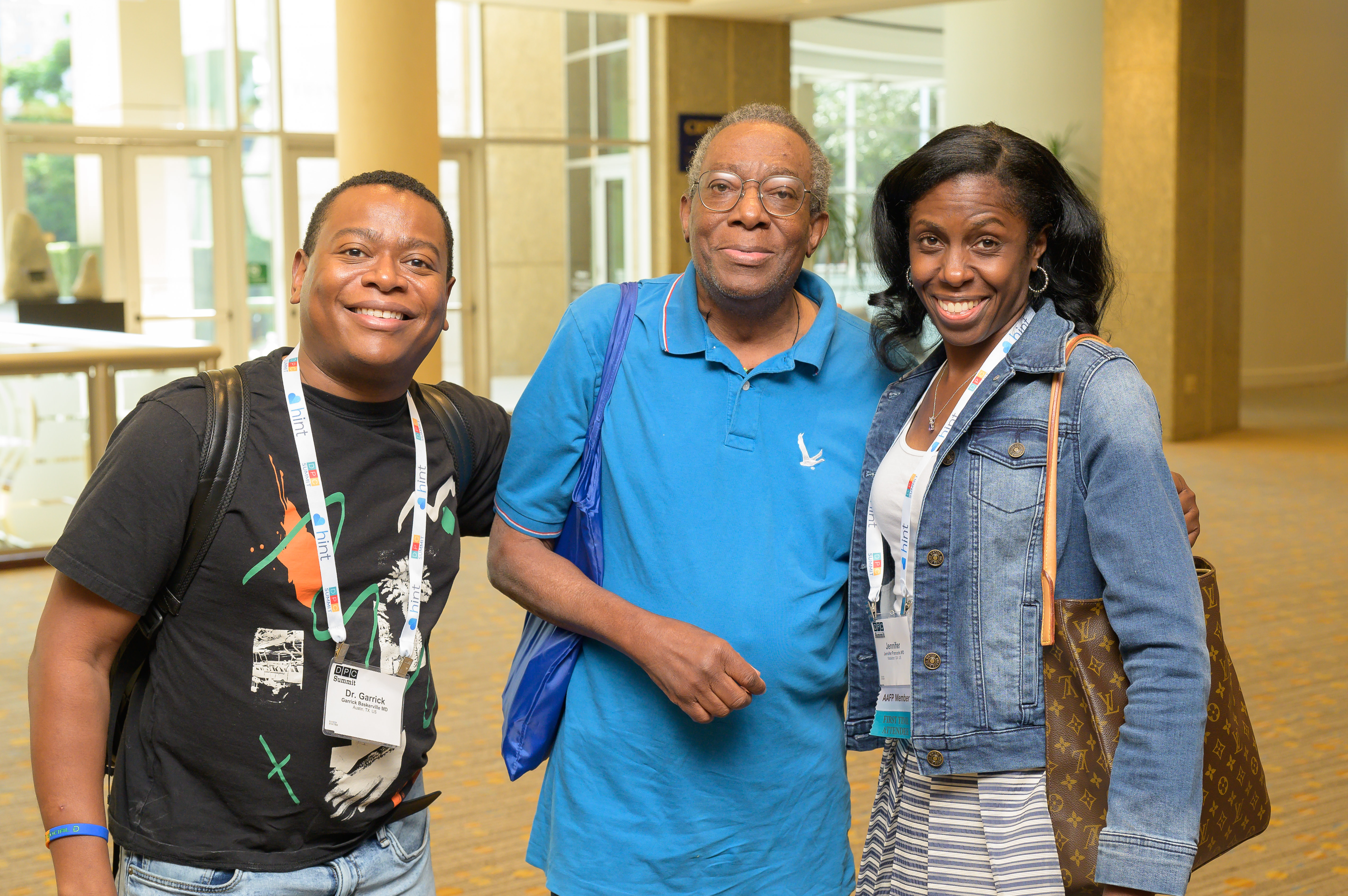 Three doctors posing for picture and smiling at the camera